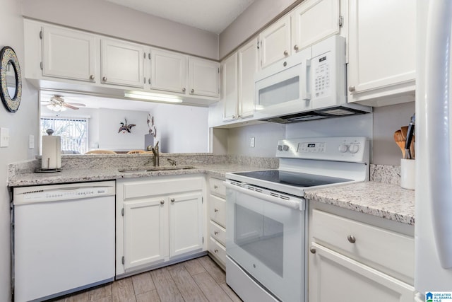 kitchen featuring white appliances, ceiling fan, sink, light hardwood / wood-style floors, and white cabinetry