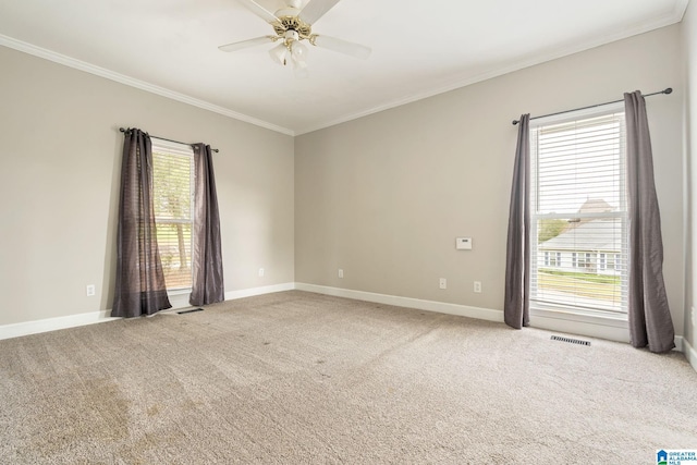 carpeted spare room featuring ceiling fan and ornamental molding