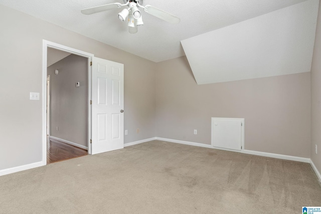 bonus room with light carpet, a textured ceiling, ceiling fan, and lofted ceiling