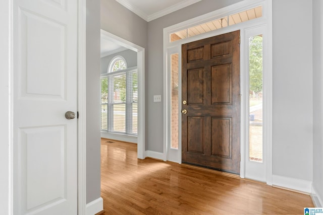 entryway featuring light hardwood / wood-style flooring, plenty of natural light, and crown molding