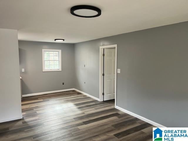 spare room featuring dark wood-type flooring