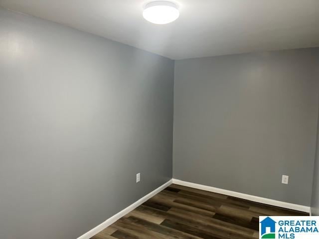 empty room featuring dark wood-type flooring