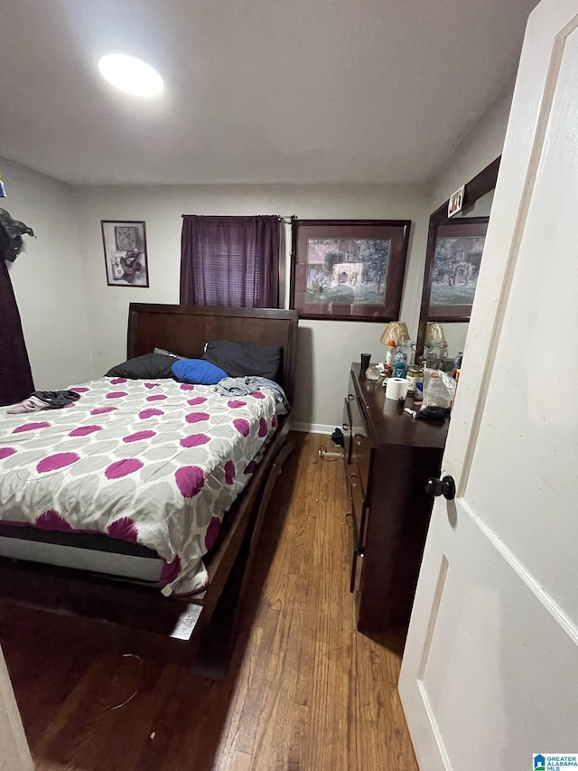 bedroom with wood-type flooring