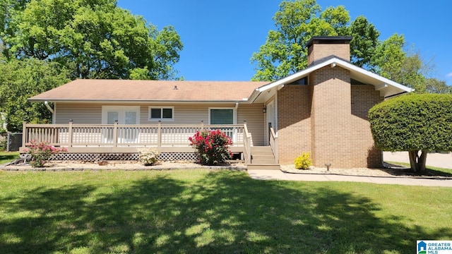 1828 Canyon Rd, Vestavia Hills, AL 35216 - back of house with a wooden deck, a lawn, a chimney, and brick siding