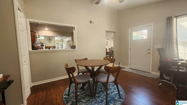 dining area featuring ceiling fan and dark wood-type flooring