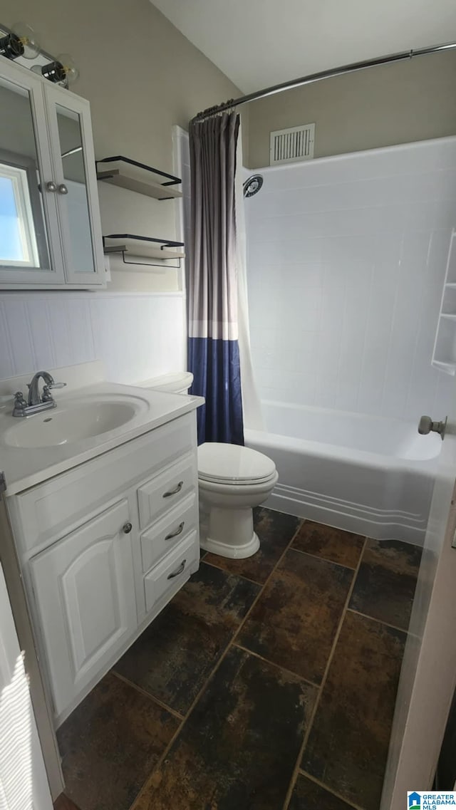 full bathroom featuring vanity, shower / bath combo, and toilet