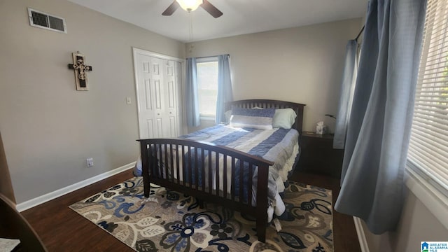 bedroom featuring ceiling fan, dark wood-type flooring, and a closet