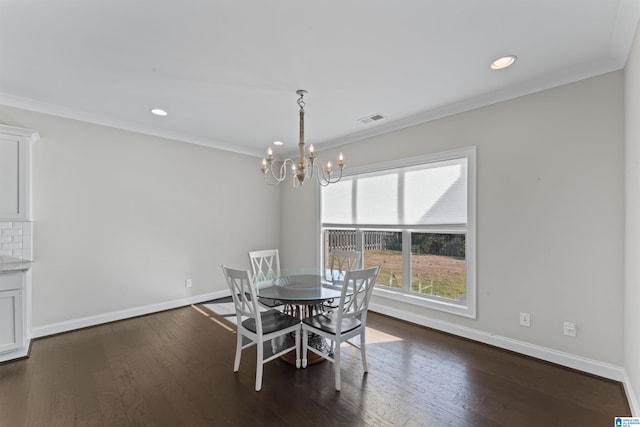 unfurnished dining area with crown molding, a chandelier, and dark hardwood / wood-style floors