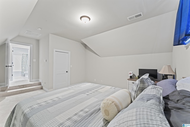 carpeted bedroom with vaulted ceiling