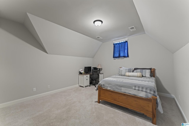 bedroom with light carpet and lofted ceiling