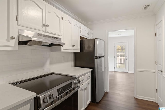 kitchen with dark wood-type flooring, ornamental molding, tasteful backsplash, white cabinetry, and stainless steel appliances