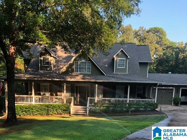 view of front of property with a porch, a garage, and a front yard