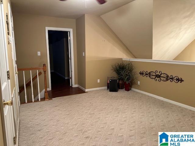 bonus room with ceiling fan, light colored carpet, and vaulted ceiling