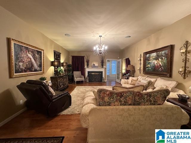 living room featuring a notable chandelier and wood-type flooring