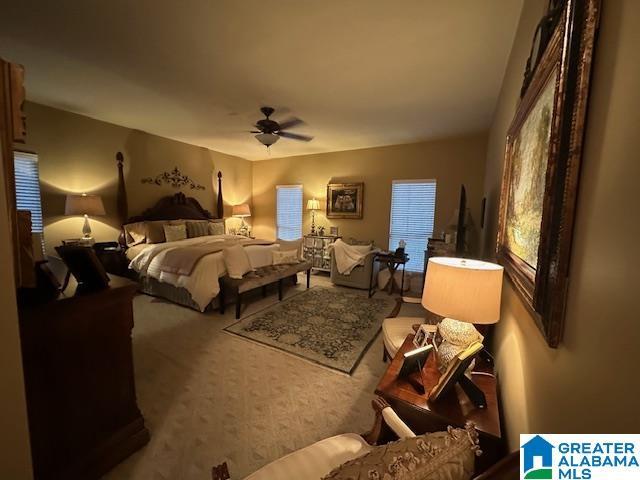 bedroom featuring carpet flooring, multiple windows, and ceiling fan