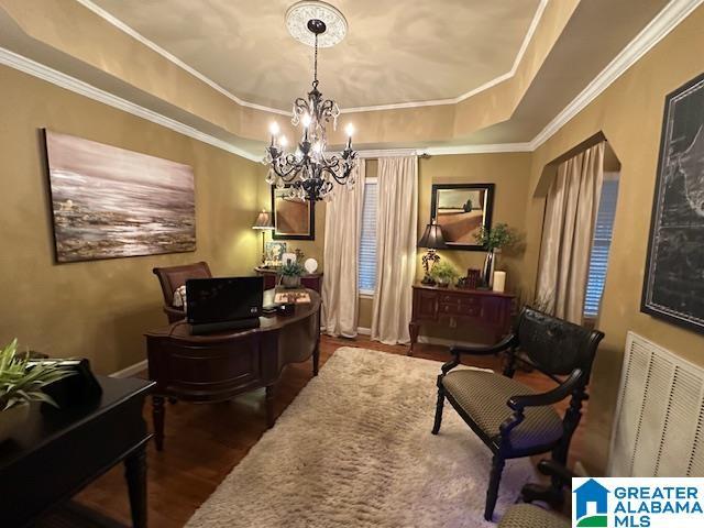 home office with a raised ceiling, a notable chandelier, dark hardwood / wood-style flooring, and crown molding