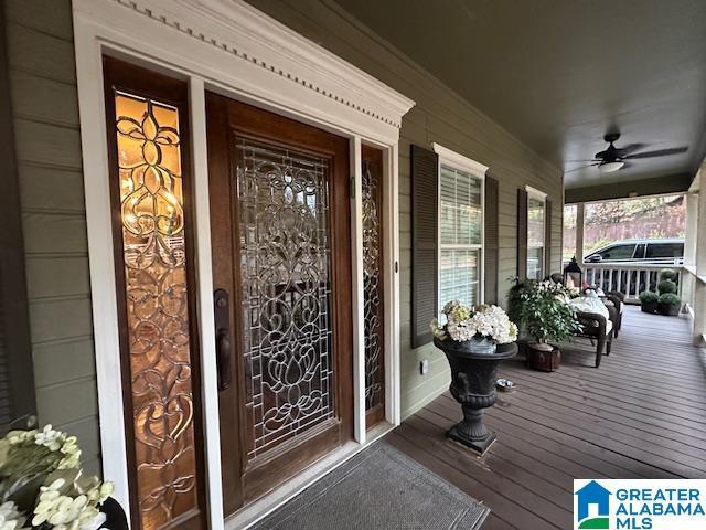 property entrance featuring ceiling fan and a porch