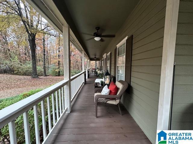 wooden terrace featuring ceiling fan and covered porch