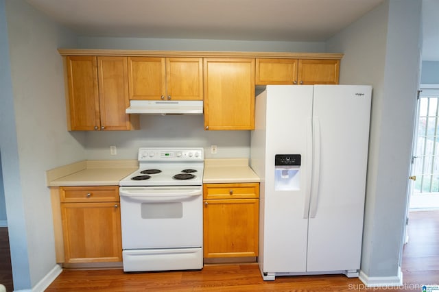 kitchen featuring light hardwood / wood-style floors and white appliances