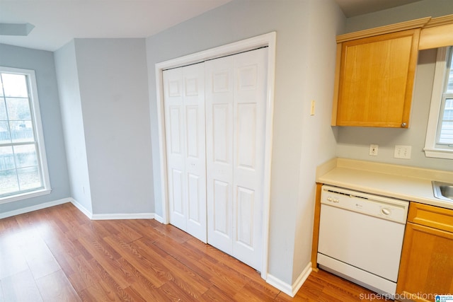 kitchen with light wood-type flooring and white dishwasher