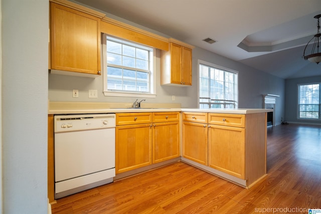 kitchen featuring white dishwasher, kitchen peninsula, sink, and light hardwood / wood-style flooring