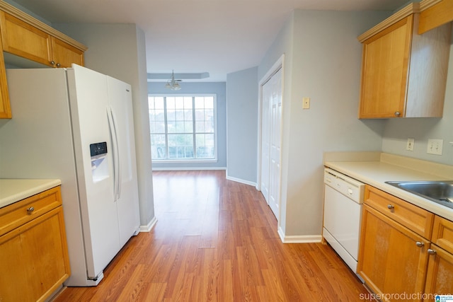 kitchen featuring light wood-type flooring, white appliances, ceiling fan, and sink