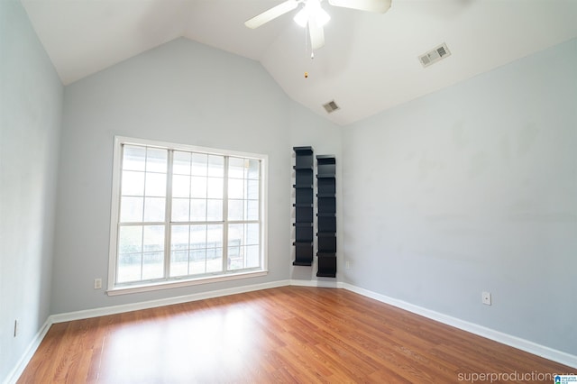 unfurnished room featuring ceiling fan, vaulted ceiling, and light wood-type flooring