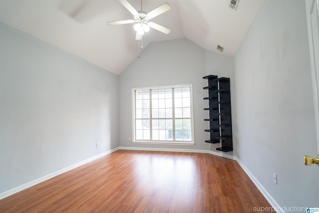 unfurnished room featuring hardwood / wood-style flooring, vaulted ceiling, and ceiling fan