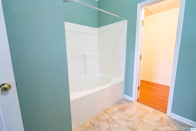 bathroom with hardwood / wood-style floors and bathtub / shower combination