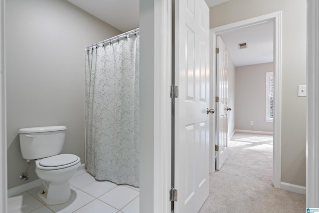 bathroom with tile patterned flooring and toilet