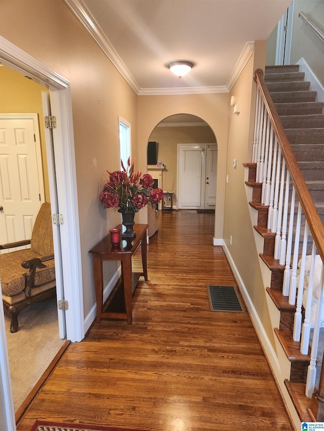 corridor with dark hardwood / wood-style floors and crown molding