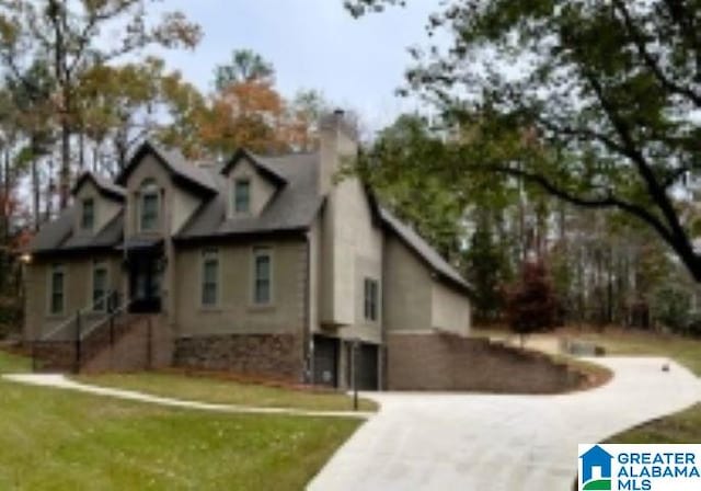 view of front of house featuring a garage and a front lawn