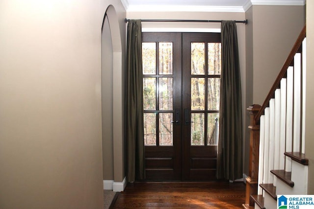 entryway featuring french doors, crown molding, dark wood-type flooring, and a healthy amount of sunlight