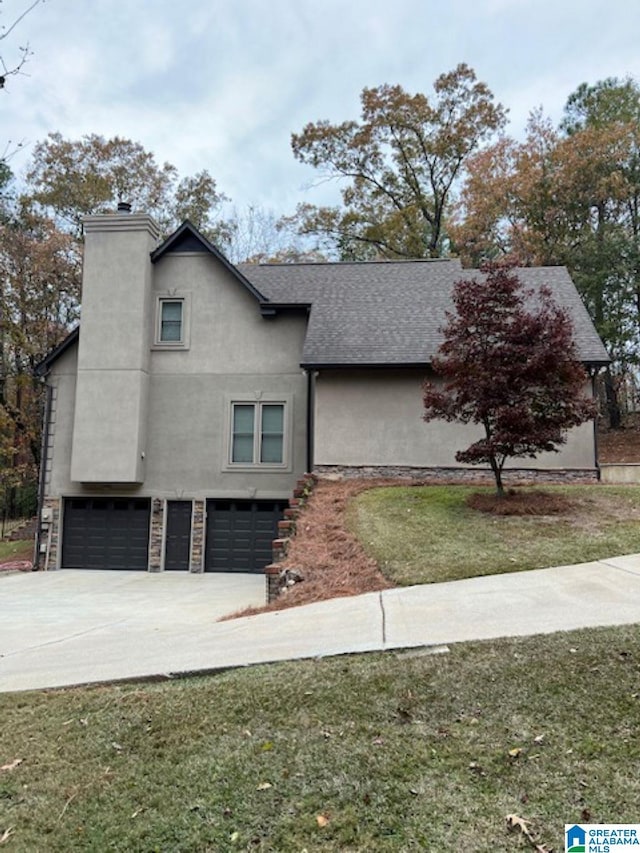 view of front of property with a front yard and a garage