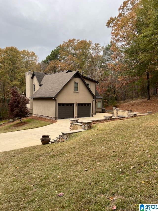 view of home's exterior featuring a lawn and a garage