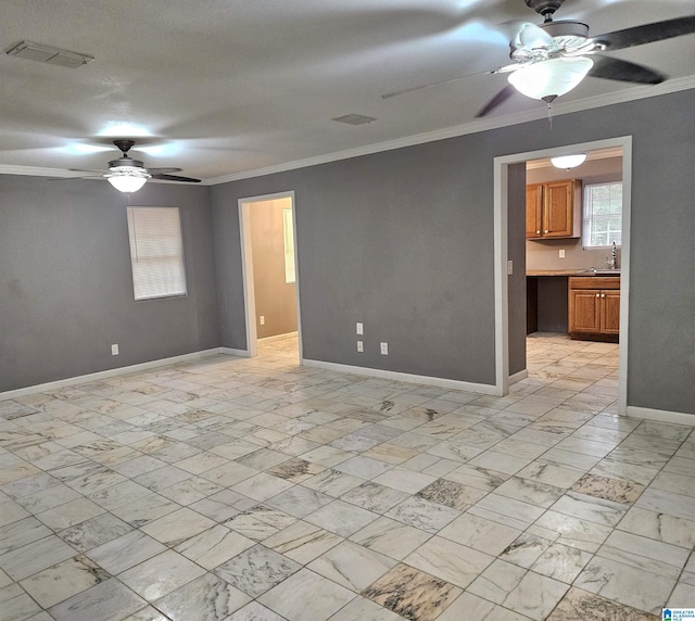 unfurnished room featuring sink and crown molding