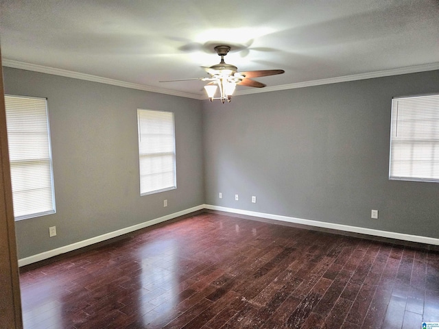 empty room with crown molding, ceiling fan, and dark wood-type flooring