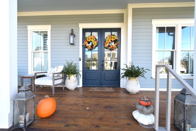 entrance to property with french doors and a porch