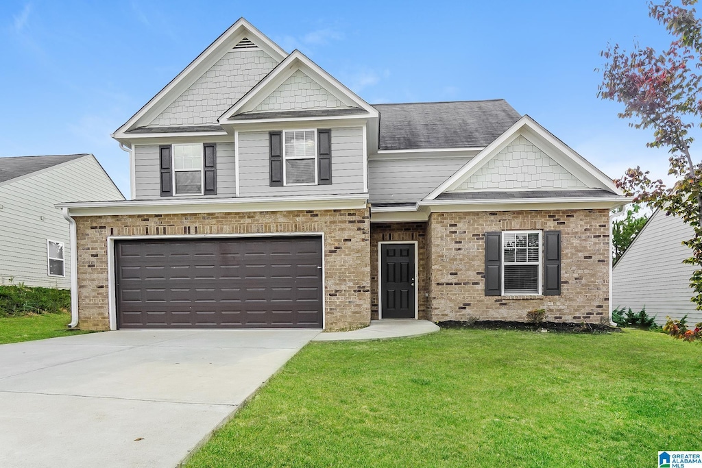 craftsman-style house featuring a garage and a front lawn