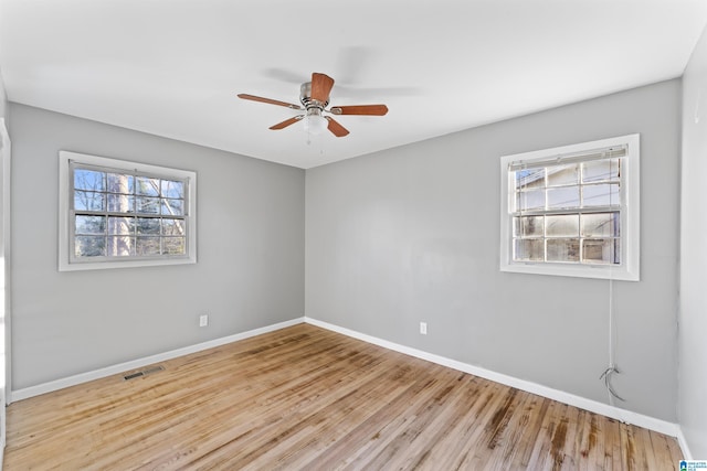 empty room featuring ceiling fan and light hardwood / wood-style flooring