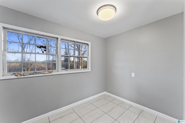 unfurnished room featuring light tile patterned floors