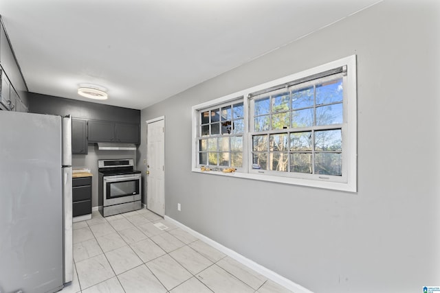 kitchen with stainless steel electric stove and refrigerator