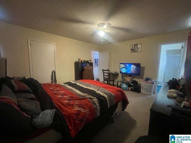 carpeted bedroom featuring ceiling fan and a textured ceiling