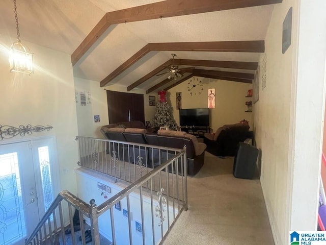 interior space featuring lofted ceiling with beams, ceiling fan, and french doors