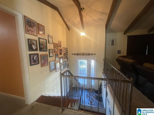 staircase featuring carpet and beam ceiling