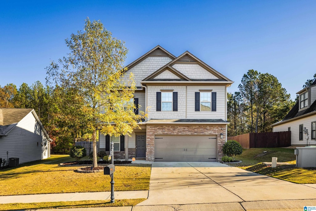 craftsman house featuring central AC unit, a garage, and a front lawn