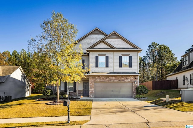 craftsman house featuring central AC unit, a garage, and a front lawn