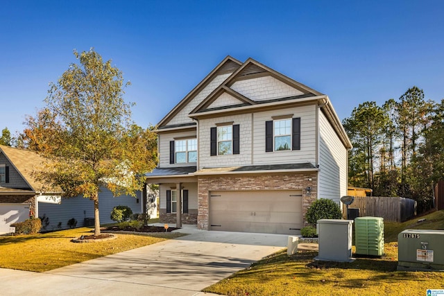 craftsman house featuring a garage and a front lawn