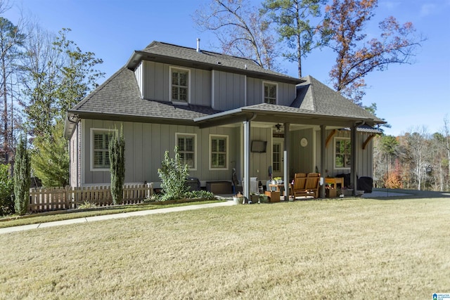 back of property featuring an outdoor living space and a yard