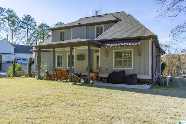 back of house with outdoor lounge area, a yard, and central AC